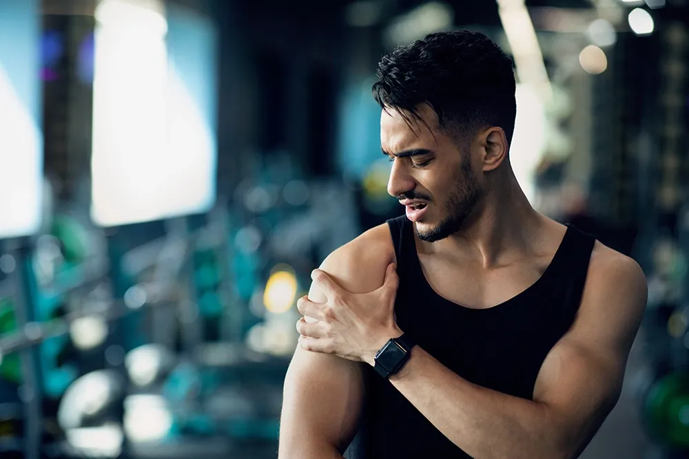 Man at the gym with a shoulder injury