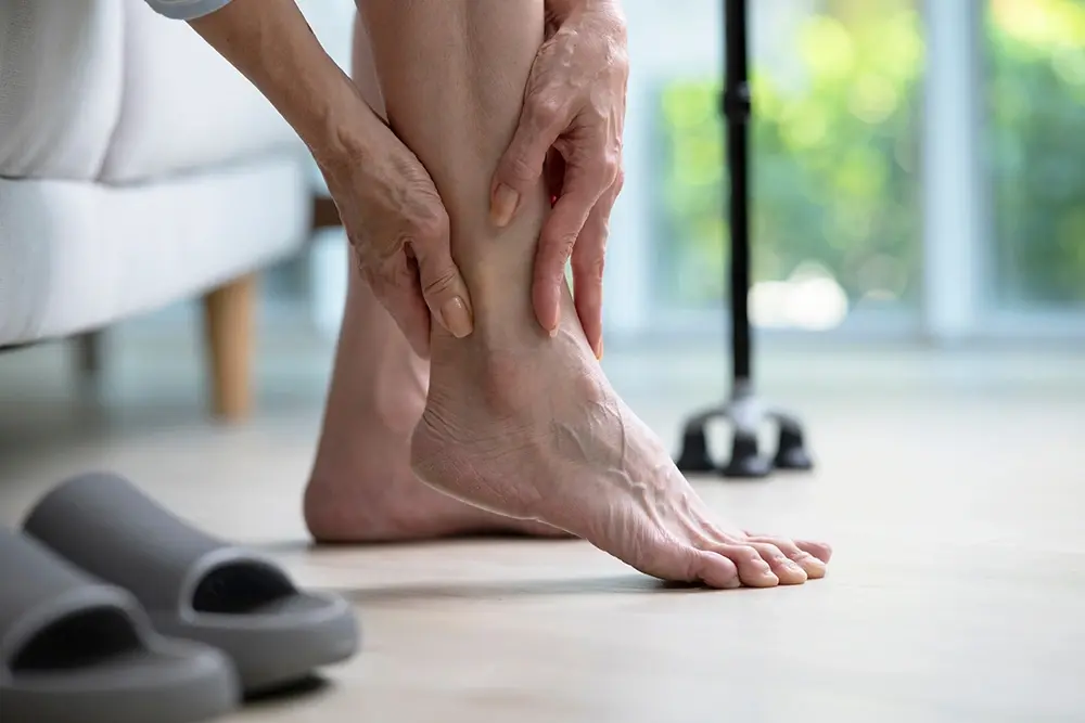 An elderly woman suffering from ankle pain
