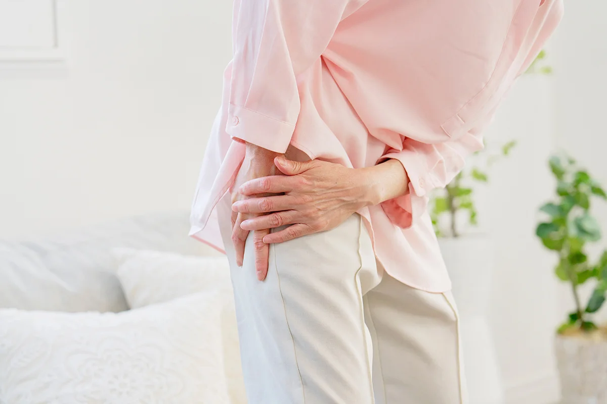 Elderly woman experiencing thigh pain due to a possible hip problem