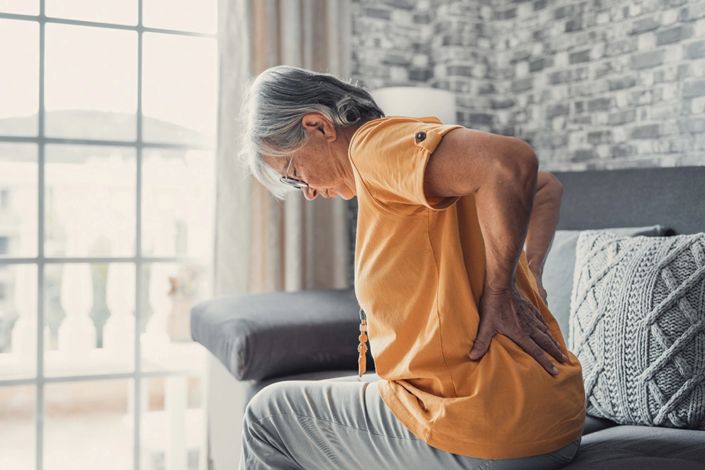 An older woman suffering from sciatica pain