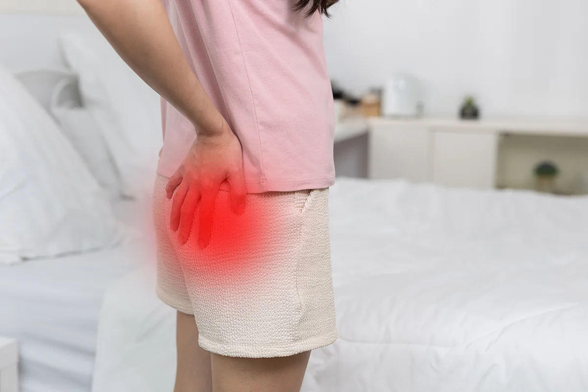 Woman holding her hip while experiencing hip pain