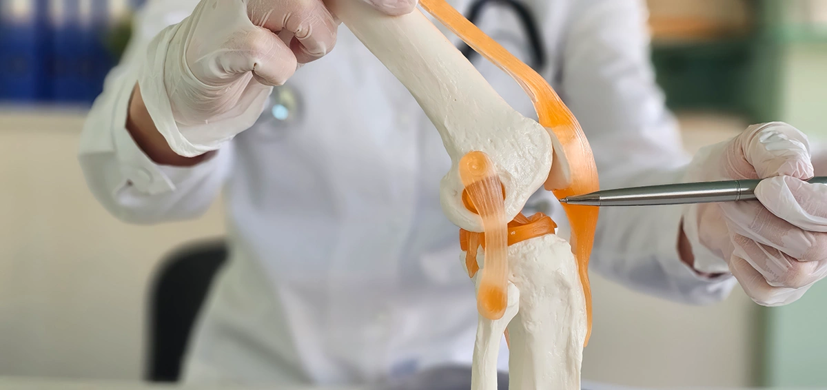 Sports injury specialist assessing patient’s knee