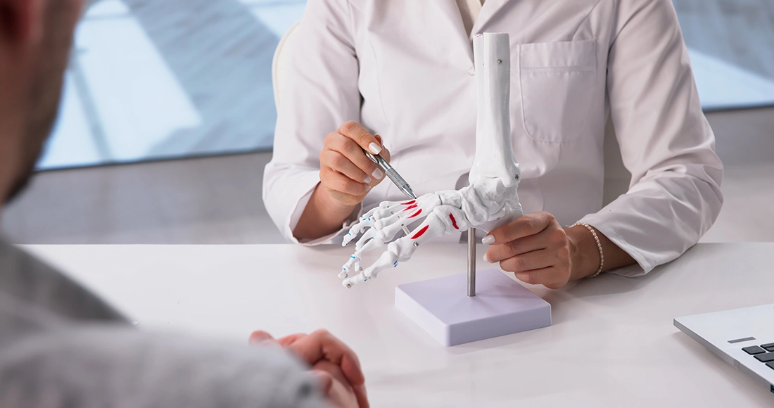 A specialist explaining treatment for outer foot pain