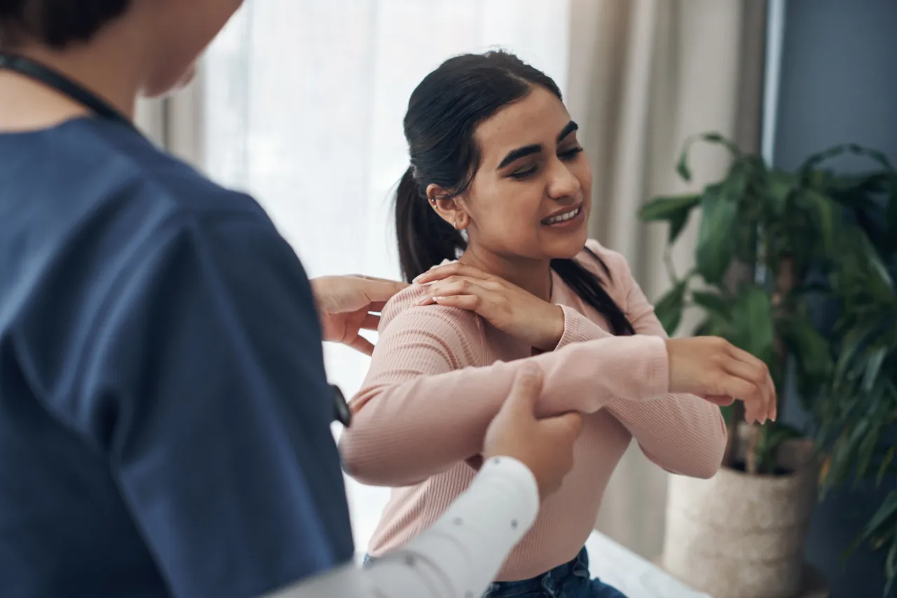Woman at a specialist appointment for shoulder pain