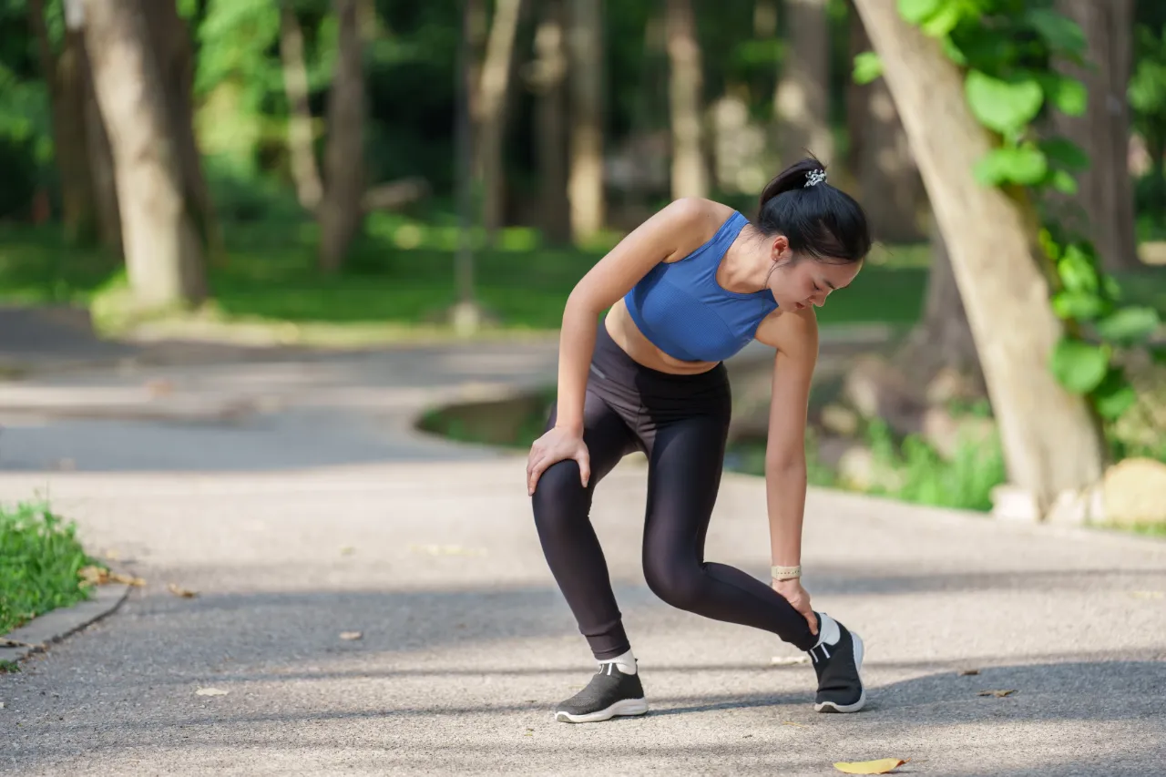 Woman with ankle pain at the park
