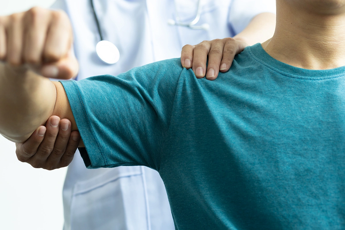 Shoulder specialist assessing patient’s shoulder